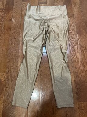 Athleta Gold Embossed Salutation 7/8 Tights